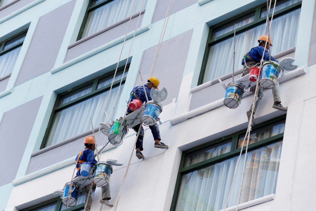 Painters working on a high-rise commercial building